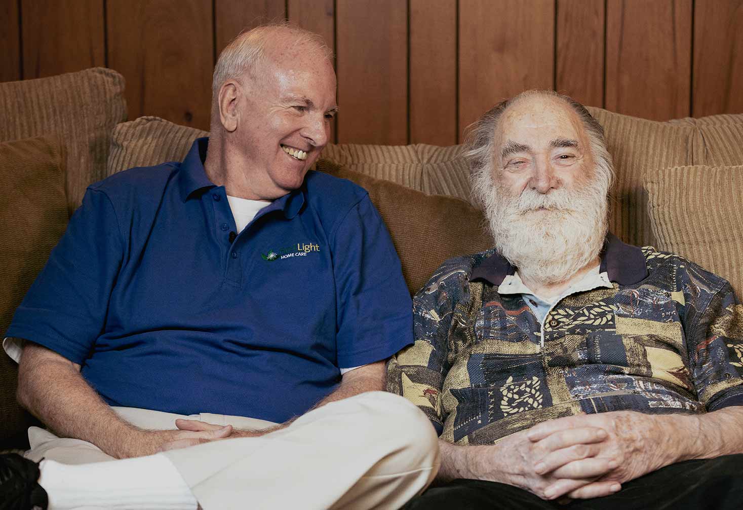 FirstLight Caregiver of the Year Brian sits and laughs with a client